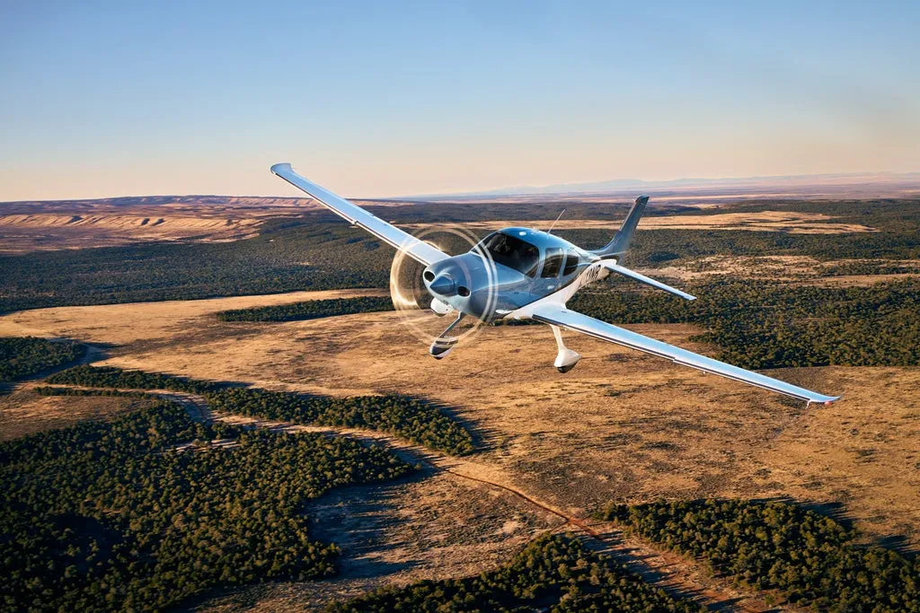 Cirrus SR22 G7 turning above the forest at sunset